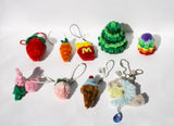 Collection of colorful keychains shaped like various items on a white background