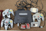 n64 with controllers and memory cards